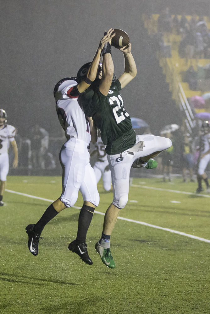 Cave Spring's (15) Ben Robinson breaks up a pass in the end zone against Glenvar's (21) Colby Street.